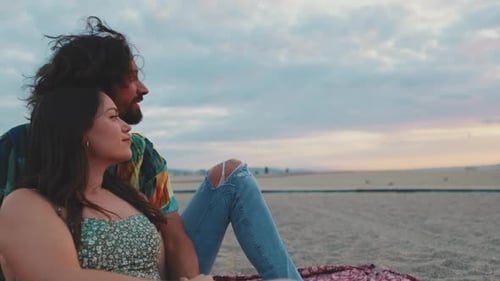 Couple in love enjoy beautiful view at sunrise on the beach