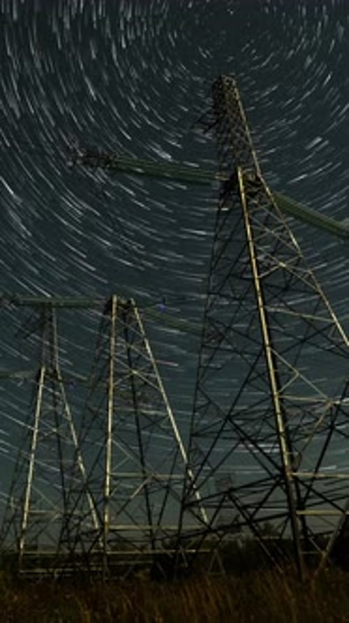 Power Lines with Star Trails at Night Portrait View