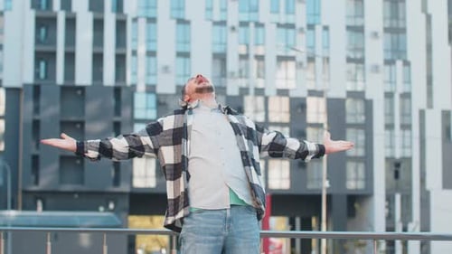 Excited Man Looking Surprised Clenching Fists Shocked By Sudden Victory Standing on City Street