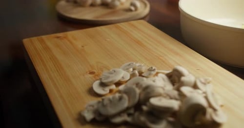 Mushroom Slices Being Prepared for Cooking on Wood