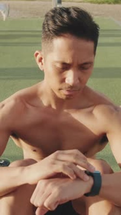 Young Adult Using Smartwatch After Workout