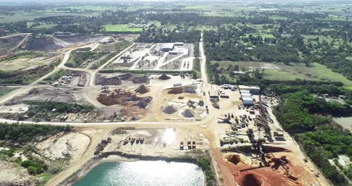 Large quarry with heavy machinery operating to deliver soil and minerals to their customers.