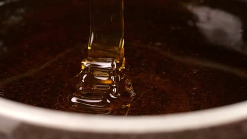 Fresh Honey Flowing Into A Bowl On The Black Background, Sweet Dessert