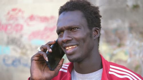 Young Adult Chatting on Mobile Phone in City