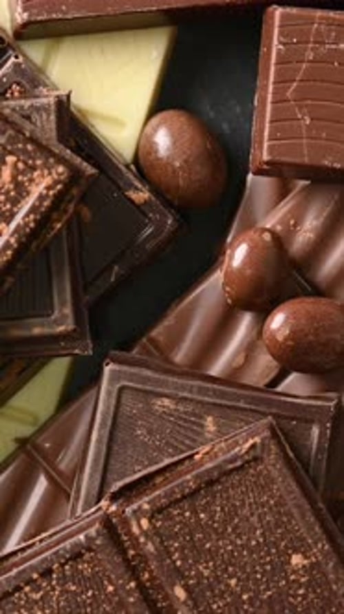 Assortment of white, milk and dark chocolate pieces background