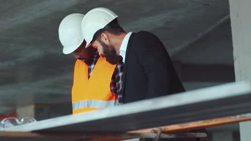 Close Up View of Professional Multiracial Construction Engineers Working Hard on the Project