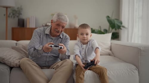 Grandfather and Child Playing Video Games on Couch