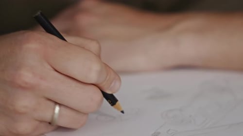 Relaxing Sketch Male Hand Drawing Small Details with Pencil on Paper