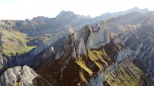 Aerial flyover alongside Schaefler ridge in Appenzell, Switzerland with side view of the cliffs of A