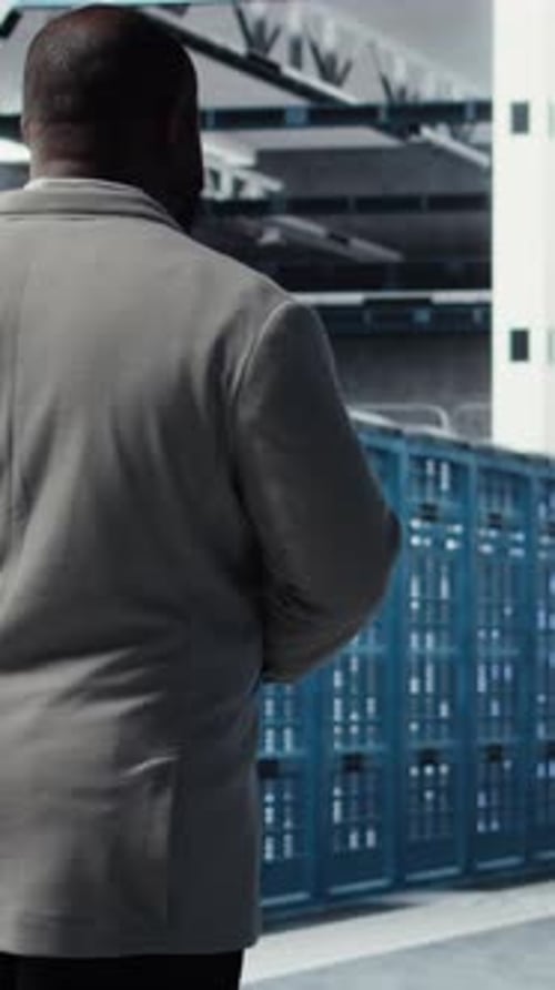 Vertical Video Admin Walking in Data Center Doing Inspection on Infrastructure Tech