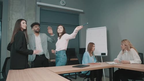 Team collaborates in modern office space discussing project details with documents in hand