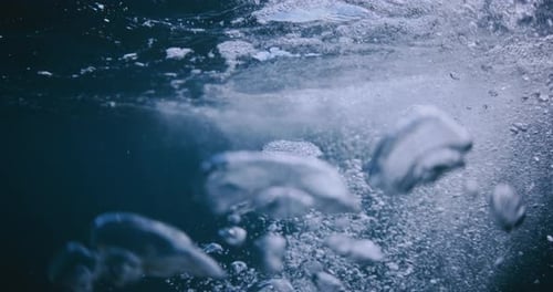 Underwater blue texture in transparent ocean. Bubbles in tropical sea.