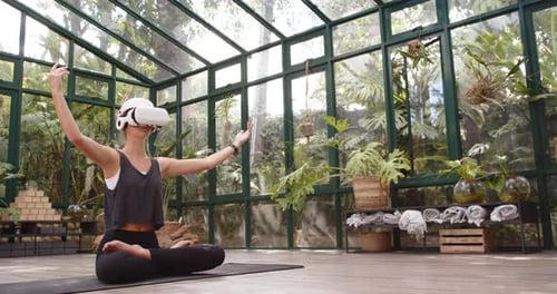 Woman Practicing Yoga with VR Headset in Garden