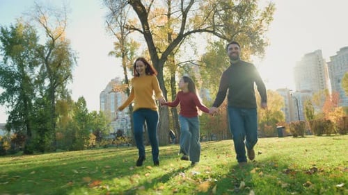 Active Happy Family Parents Mother Father with Daughter Girl Child Kid Run in Sunny Day Park Having