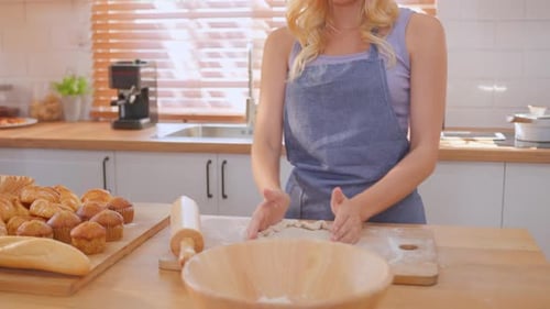 Close up of woman kneaded yeast dough with hands in kitchen at home.