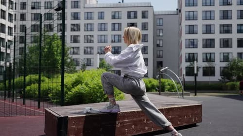 Young Woman Exercising Outside in City Park