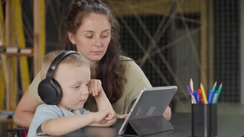 Mother and Young Son Use Tablet Together