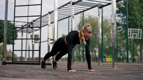Athletic Woman Doing Push-Ups at Outdoor Gym