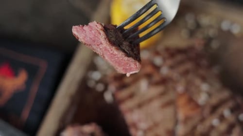 a restaurant guest cuts a steak