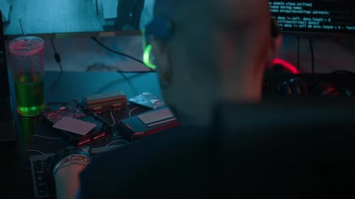 Cyberpunk style hacker using keyboard near monitors