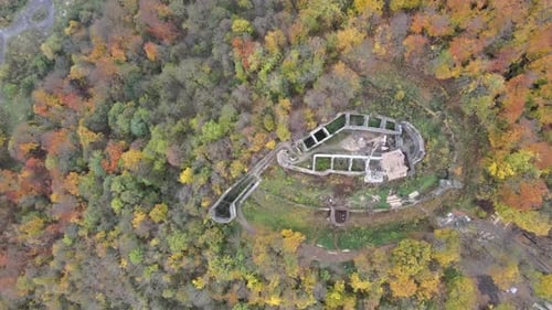 Aerial View of Castle Ruins in Autumn Forest
