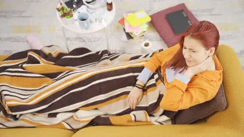 Woman Resting on Couch with Blanket