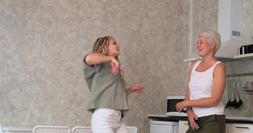 Two Women Dancing Together in a Kitchen