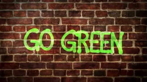 Go green spray painted on the brick wall