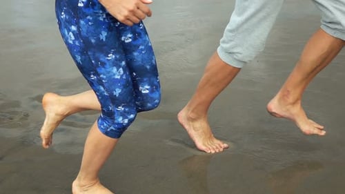 Couple Of Joggers Running On Beach, Super Slow Motion 240fps