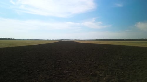 Tractors plowing the field in Ukraine