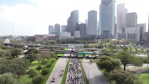 Top down Aerial of people competing in city marathon on the main road. Athletes taking part in outdo