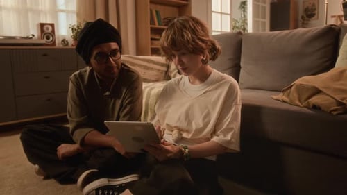 Couple Using Tablet Together at Home Indoors