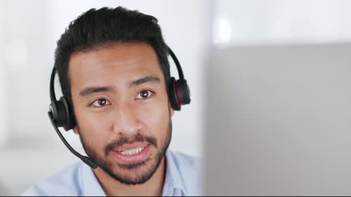 A call center agent consulting a client via video call in an office