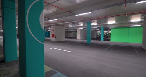 right to Left pan shot Empty Electric Vehicle Charging Spots In A underground Parking Lot