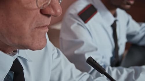 Adult Speaking at Corporate Conference with Microphone