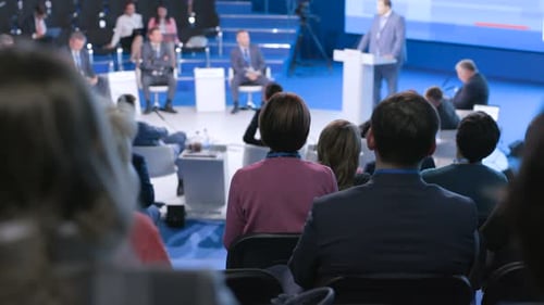 Large audience listening to speaker at business conference