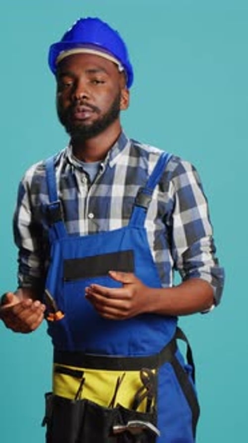 Vertical Video Dizzy Construction Worker Feeling Light Headed in Studio