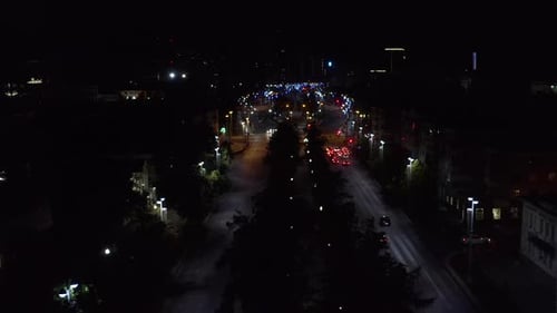 Top view of dark city at night with glowing lanterns