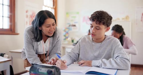 Teacher Helping Student with Schoolwork in Classroom