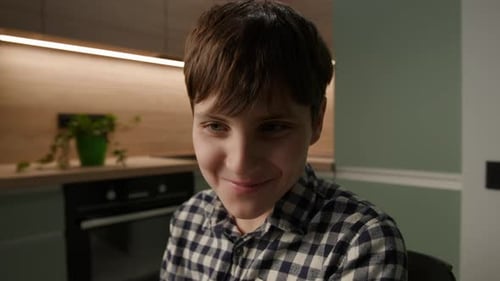 Young Adult Smiling Indoors Wearing Plaid Shirt