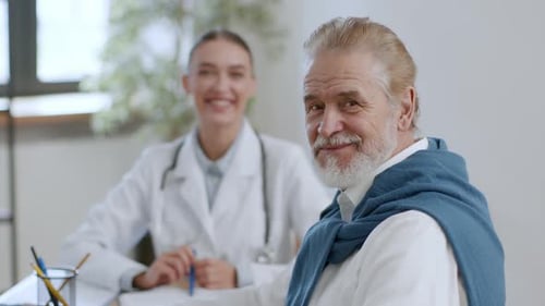 Doctor Consults with Senior Patient in Medical Office