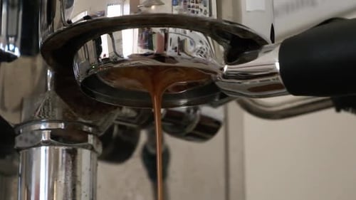 Closeup of espresso pouring from a naked portafiller