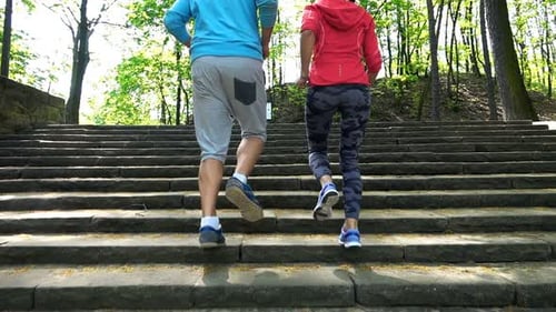 Active Young Couple Jogging Up The Stairs In The Park, Super Slow Motion
