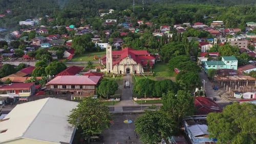 Cabalian Historical Church In The Coastline Of Southern Leyte With Crane Vessel At The Harbour Revea