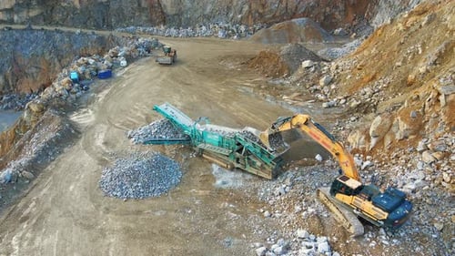 Efficient Mining Operations: An Excavator, Tracked Incline Screener, and Wheel Loader at Work at a Q