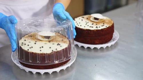 Cakes Being Placed in Containers