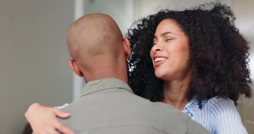 Woman Embraces Bald Man Inside Home