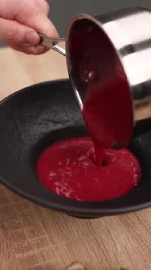 The chef is preparing a puree soup in the kitchen. Close-up
