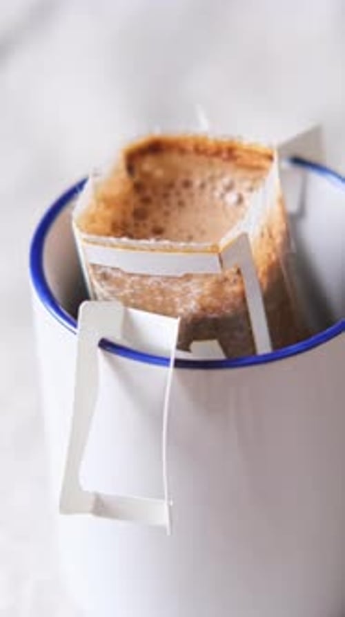 Drip Coffee Filter Being Poured into Mug