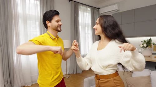 Cheerful Couple Dancing Together at Home